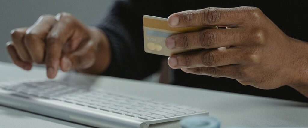 A person looking at a laptop with a comparison of different high yield savings accounts and their annual percentage yield (APY)