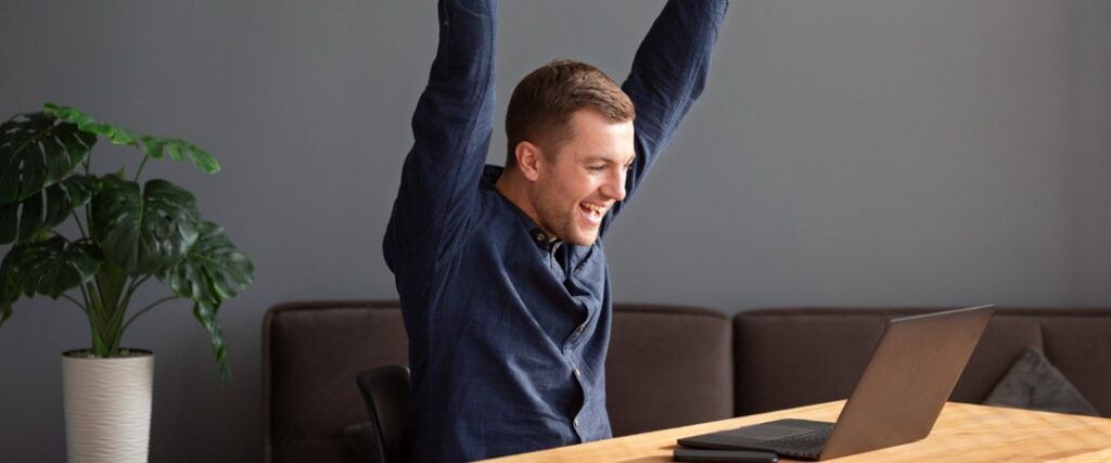 A person looking at a laptop with a graph showing financial independence