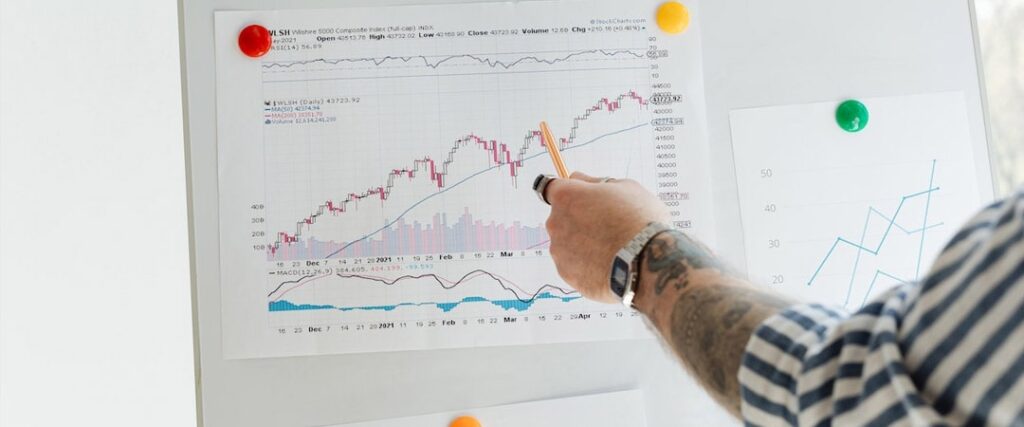 A person looking at a laptop with a graph showing the success stories of FIRE followers