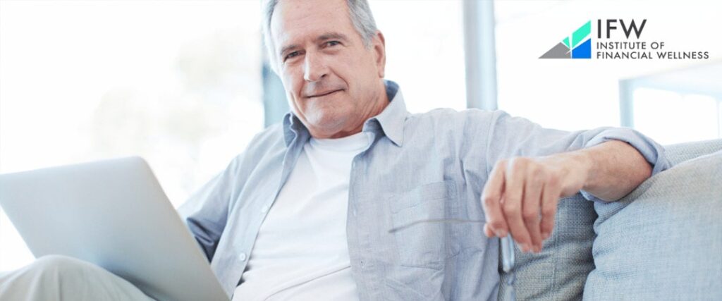 An image of a senior person in a business suit working on a laptop, representing the concept of working after retirement as discussed in the Institute of Financial Wellness' tips for success.