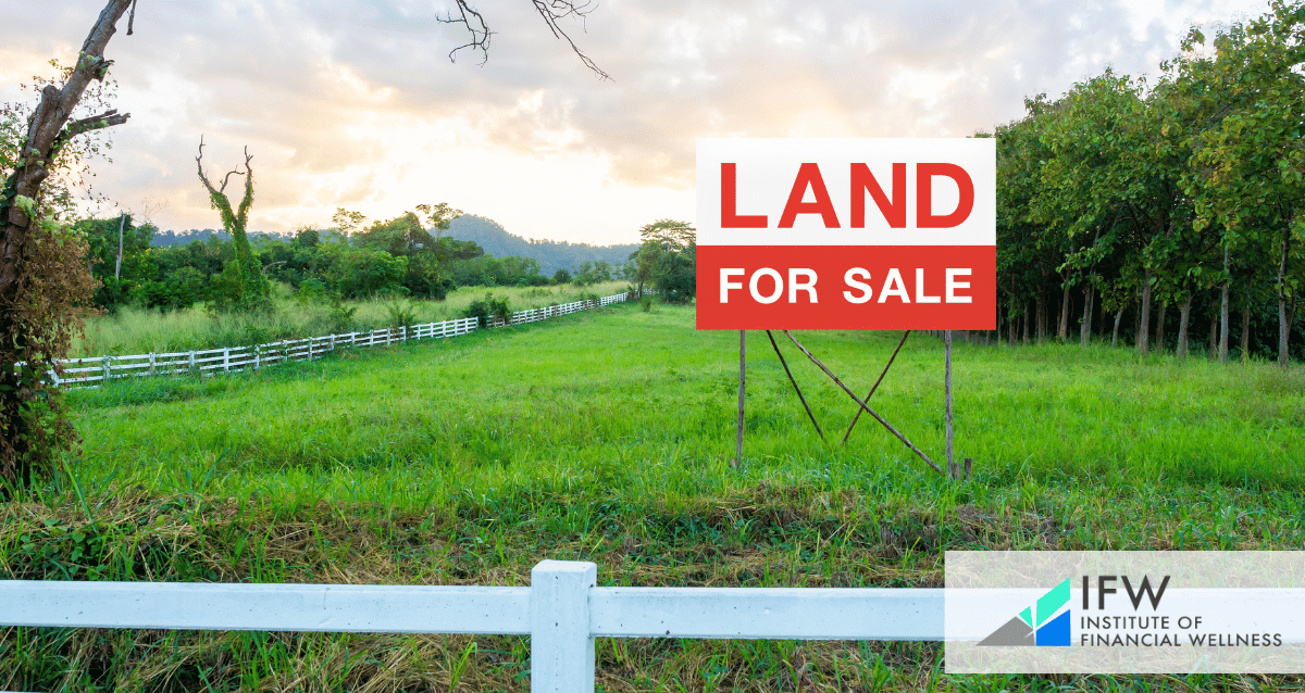 An image of a land with a sign that reads "land for sale"