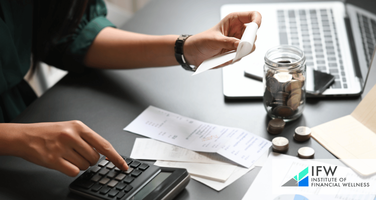 A photo of a person with bills, a computer and a calculator