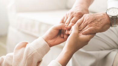 Elderly person holding hands with a child