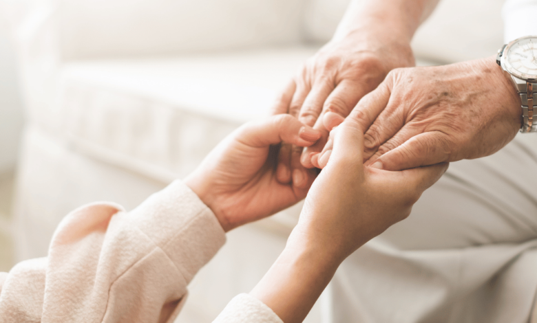 Elderly person holding hands with a child