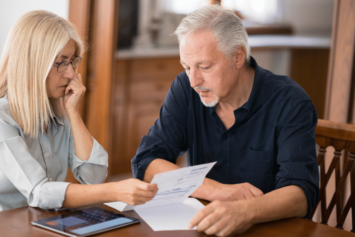 Middle-aged couple reviewing retirement account statements