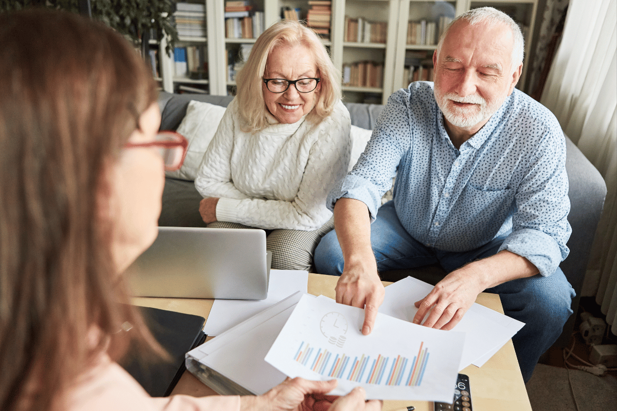 Elderly couple showing a chart indicating how they're maximizing their retirement savings