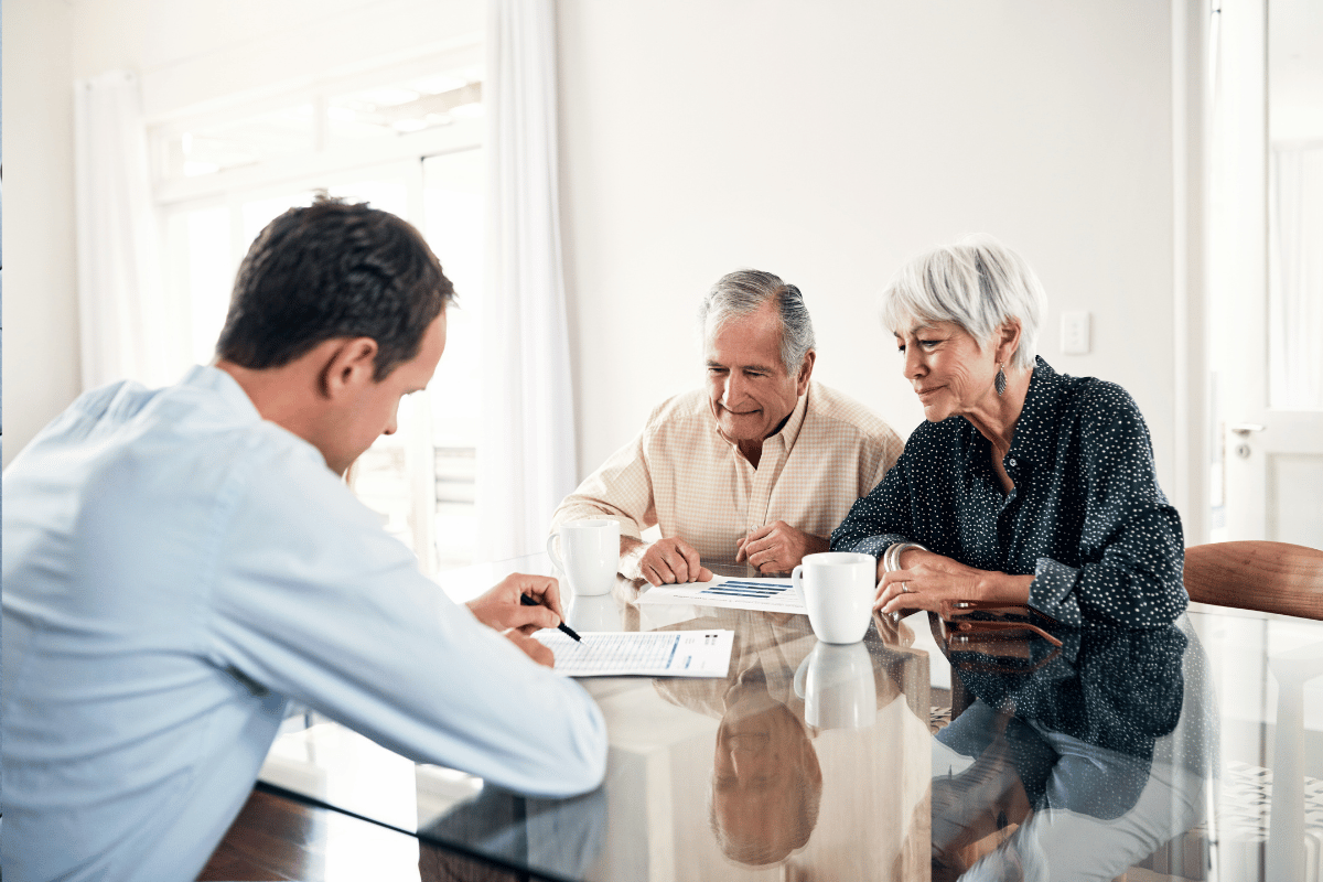 Elderly couple consulting a financial advisor for retirement planning