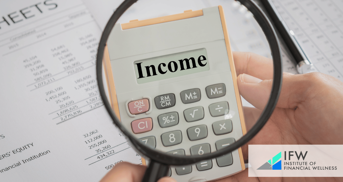 An image of a magnifying glass over a calculator with the word "income"