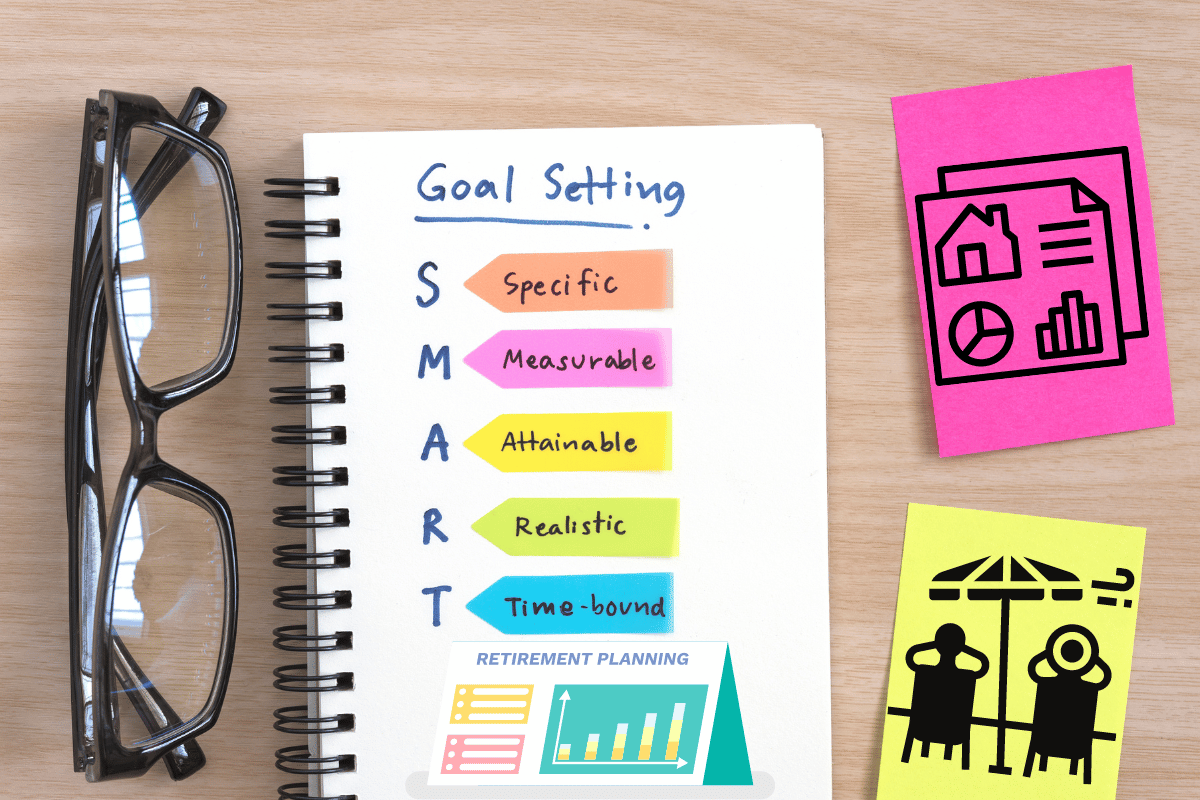 Retirement SMART goals in a notebook between a pair of glasses and sticky notes