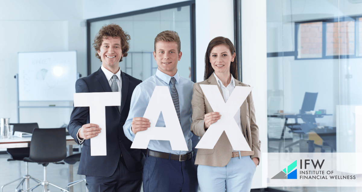 A photo of 3 people holding the letters that make the word TAX