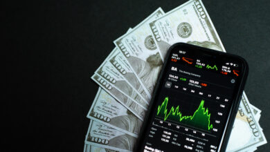 Samara Russia - 04.05.2020: Shares of a Boeing company on the screen of iPhone 11 against the backdrop of hundred-dollar bills. The fall and growth of stocks, the concept of a brokerage account