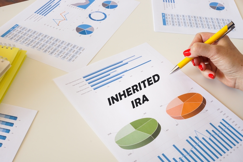 Business concept meaning INHERITED IRA with inscription on the financial document.