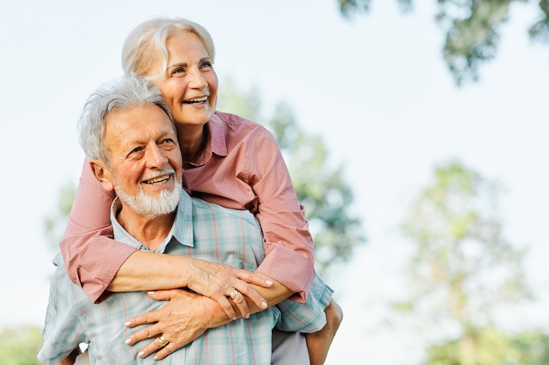 Happy active senior couple having fun outdoors. Portrait of an elderly couple together